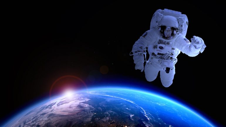 astronaut in space with earth in distance